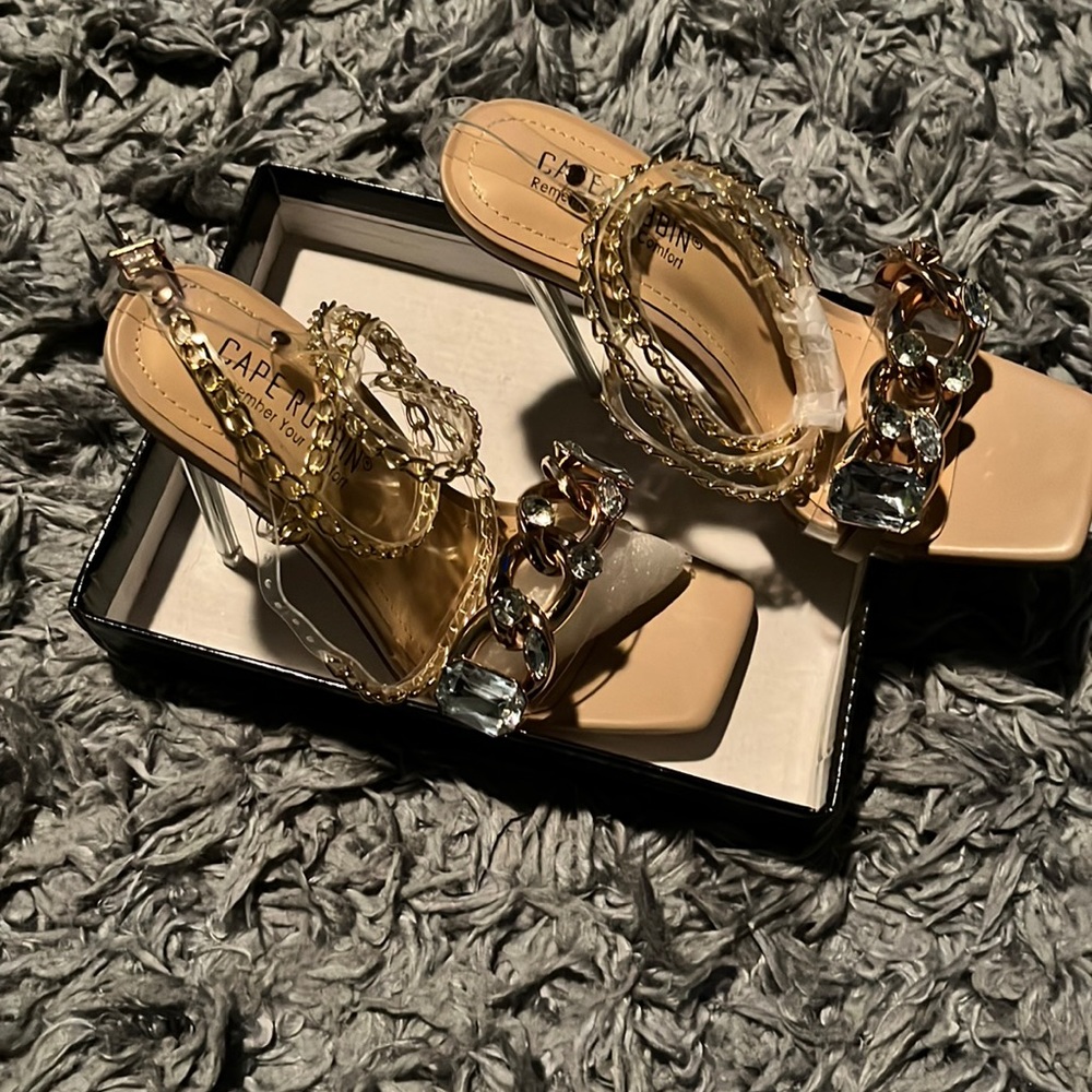 Sexy clear nude pump with ankle buckle and rhinestone toe strap.
